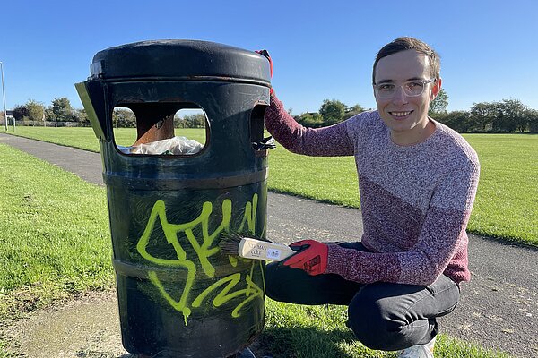 James cleaning graffiti 